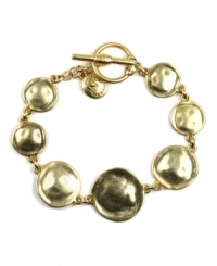 Encircle your wrists in style that stands out. Bracelet by Jones New York features a chic, circular design and toggle clasp. Crafted in gold tone mixed metal. Approximate length: 7-3/4 inches.