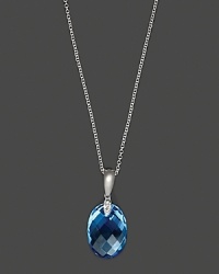 Diamonds accent a checkerboard blue topaz, set in 14K white gold. Diamonds accent a checkerboard blue topaz, set in 14K white gold.