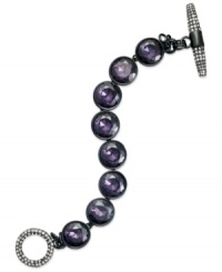 Purple reigns. This toggle bracelet from Juicy Couture showcases round glass stones in purple hues. Finished with a toggle closure embellished with pave accents. Crafted in silver tone mixed metal. Approximate length: 7-1/2 inches. Purple reigns. This toggle bracelet from Juicy Couture showcases round glass stones in purple hues. Finished with a toggle closure embellished with pave accents. Crafted in silver tone mixed metal. Approximate length: 7-1/2 inches.