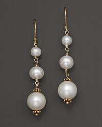 Graduated freshwater pearls gleam in a 14K. yellow gold setting. Graduated freshwater pearls gleam in a 14K. yellow gold setting.