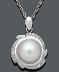 Prim and polished. This sophisticated pendant highlights a cultured freshwater pearl (9-10 mm) encircled by a pretty petal design accented with sparkling diamonds. Set in sterling silver. Approximate length: 18 inches. Approximate drop: 3/4 inch. Prim and polished. This sophisticated pendant highlights a cultured freshwater pearl (9-10 mm) encircled by a pretty petal design accented with sparkling diamonds. Set in sterling silver. Approximate length: 18 inches. Approximate drop: 3/4 inch.
