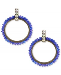 Amp up your wardrobe with a bold pop of color. Betsey Johnson's 80s-themed doorknocker earrings feature faceted blue beads and crystal accents at the post. Crafted in antiqued gold tone mixed metal. Approximate drop: 2-3/4 inches.