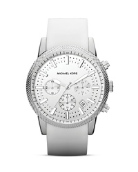 A crisp, clean look defines this Michael Kors timepiece, which features a silver chronograph dial set against a complementary silicone strap. A crisp, clean look defines this Michael Kors timepiece, which features a silver chronograph dial set against a complementary silicone strap.