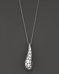 A beautifully textured silver drop is elegant suspended from a gleaming chain. A beautifully textured silver drop is elegant suspended from a gleaming chain.