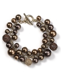 In a rich hue, Carolee's clustered pearl charm bracelet is understated by stylish, perfect to wear now and for seasons to come. In a rich hue, Carolee's clustered pearl charm bracelet is understated by stylish, perfect to wear now and for seasons to come.