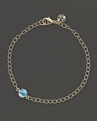 A single faceted blue topaz adds a spot of brilliant color to elegant 18K yellow gold links. By Carelle. A single faceted blue topaz adds a spot of brilliant color to elegant 18K yellow gold links. By Carelle.