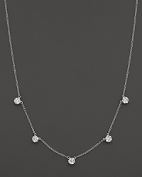 Five diamond cluster stations in a 14K white gold necklace. Five diamond cluster stations in a 14K white gold necklace.