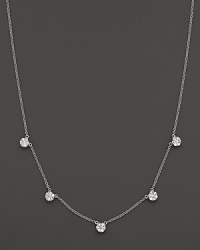 Five diamond cluster stations in a 14K white gold necklace.