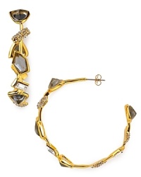 Glittering geometric stones put a rock and roll twist on traditional hoops. By Alexis Bittar. Glittering geometric stones put a rock and roll twist on traditional hoops. By Alexis Bittar.