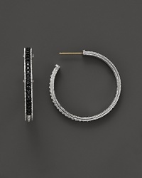Sparkling sapphires detail a classic pair of sterling silver hoop earrings from Judith Ripka. Sparkling sapphires detail a classic pair of sterling silver hoop earrings from Judith Ripka.
