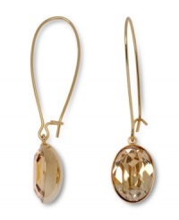 Gold rush. Inspired by young Hollywood, a trendy golden shadow crystal adds a dramatic design detail to Swarovski's linear drop earrings. The gold tone mixed metal setting complements the golden hue of the crystal. Approximate drop: 1-3/4 inches. Gold rush. Inspired by young Hollywood, a trendy golden shadow crystal adds a dramatic design detail to Swarovski's linear drop earrings. The gold tone mixed metal setting complements the golden hue of the crystal. Approximate drop: 1-3/4 inches.