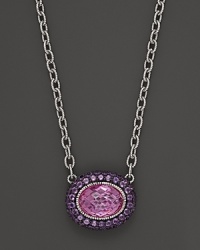 Sterling silver chain necklace adorned with an oval pink corundum pendant with amethyst pave frame. By Judith Ripka. Sterling silver chain necklace adorned with an oval pink corundum pendant with amethyst pave frame. By Judith Ripka.