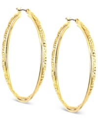 Anne Klein puts its own twist on a classic. This pair of hoop earrings is crafted from gold-tone mixed metal, and features a shapely and stylish look. Approximate diameter: 1 inch. Anne Klein puts its own twist on a classic. This pair of hoop earrings is crafted from gold-tone mixed metal, and features a shapely and stylish look. Approximate diameter: 1 inch.