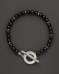 Black chalcedony gives a bold, classic look to a toggle bracelet from Gucci. Black chalcedony gives a bold, classic look to a toggle bracelet from Gucci.