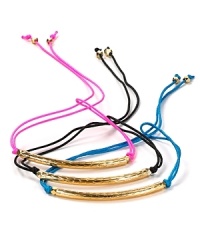 Tie on something bright with this set of colorful nylon string bracelets from Vanessa Mooney, accented by delicate brass nuggets. Tie on something bright with this set of colorful nylon string bracelets from Vanessa Mooney, accented by delicate brass nuggets.