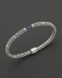 Bead-textured bracelet from Lagos in sterling silver, accented with blue sapphire. Bead-textured bracelet from Lagos in sterling silver, accented with blue sapphire.