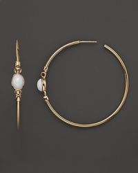 Single white agate stones are set in gleaming 18K rose gold on these stunning Di MODOLO hoop earrings. Single white agate stones are set in gleaming 18K rose gold on these stunning Di MODOLO hoop earrings.