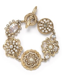As if unearthed from a socialite's jewel box, this plated floral charm bracelet from Carolee Lux has an heirloom quality with modern sparkle. As if unearthed from a socialite's jewel box, this plated floral charm bracelet from Carolee Lux has an heirloom quality with modern sparkle.