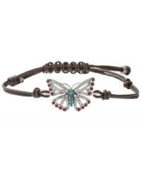 Fashionably fluttering. Fossil's free-spirited butterfly bracelet features purple and clear-colored crystals, reconstituted turquoise, and a chocolate leather adjustable wrist wrap. Set in silver tone mixed metal. Approximate diameter: 2-1/2 inches. Fashionably fluttering. Fossil's free-spirited butterfly bracelet features purple and clear-colored crystals, reconstituted turquoise, and a chocolate leather adjustable wrist wrap. Set in silver tone mixed metal. Approximate diameter: 2-1/2 inches.