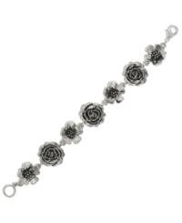 Pretty petals make perfection. Detailed floral charms make 2028's link bracelet a beauty to behold. Set in silver tone mixed metal. Approximate length: 7-1/4 inches.