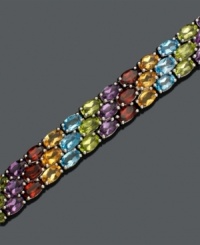 Three rows of gemstones in a myriad of vibrant color, this bracelet will turn heads. Bracelet features oval-cut blue topaz (1/4 ct. t.w.), garnet (1/4 ct. t.w.), peridot (1/4 ct. t.w.), amethyst (1/5 ct. t.w.) and citrine (1/5 ct. t.w). Set in sterling silver. Approximate length: 7-1/2 inches. Three rows of gemstones in a myriad of vibrant color, this bracelet will turn heads. Bracelet features oval-cut blue topaz (1/4 ct. t.w.), garnet (1/4 ct. t.w.), peridot (1/4 ct. t.w.), amethyst (1/5 ct. t.w.) and citrine (1/5 ct. t.w). Set in sterling silver. Approximate length: 7-1/2 inches.