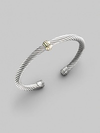 From the Cable Classics Collection. A signature Yurman sterling silver cable, richly adorned in the center with a textured band of 14k gold. Sterling silver & 14k yellow gold Cable, 5mm Diameter, about 2¼ Made in USA