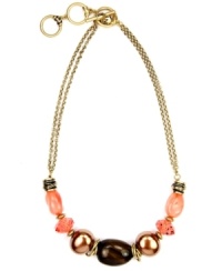 A cool splash of color. Jones New York's double strand necklace incorporates coral and shimmery beige-colored acrylic beads secured by a toggle clasp. Crafted in gold-plated mixed metal. Approximate length: 17 inches + 2-inch extender. A cool splash of color. Jones New York's double strand necklace incorporates coral and shimmery beige-colored acrylic beads secured by a toggle clasp. Crafted in gold-plated mixed metal. Approximate length: 17 inches + 2-inch extender.