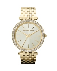 This classic style Michael Kors gold watch with a bracelet strap is an accessory staple you'll turn to time after time. This classic style Michael Kors gold watch with a bracelet strap is an accessory staple you'll turn to time after time.