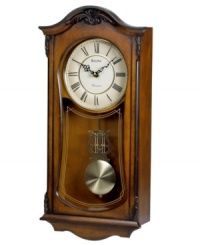 A mark of elegance. This stately wall clock by Bulova features a sturdy solid wood case with walnut finish accented by decorative carvings. White dial features Roman numerals and two hands; gold tone pendulum protected by glass lens. Plays Westminster melody on the hour. A mark of elegance. This stately wall clock by Bulova features a sturdy solid wood case with walnut finish accented by decorative carvings. White dial features Roman numerals and two hands; gold tone pendulum protected by glass lens. Plays Westminster melody on the hour.