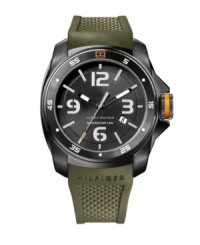 Ultra-masculine and ready to hit the ground running. Sport watch by Tommy Hilfiger crafted from olive green silicone strap and round black ion-plated stainless steel case. White numerals and orange flag logo at bezel. Black dial features stick indices, numerals at twelve, three, six and nine o'clock, date window at four o'clock, luminous hour and minute hands, orange-tipped second hand and text logo. Quartz movement. Water resistant to 50 meters. Ten-year limited warranty. Ultra-masculine and ready to hit the ground running. Sport watch by Tommy Hilfiger crafted from olive green silicone strap and round black ion-plated stainless steel case. White numerals and orange flag logo at bezel. Black dial features stick indices, numerals at twelve, three, six and nine o'clock, date window at four o'clock, luminous hour and minute hands, orange-tipped second hand and text logo. Quartz movement. Water resistant to 50 meters. Ten-year limited warranty.