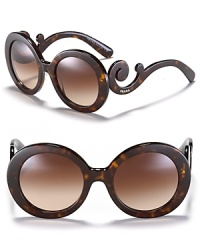 Thick round frames and curling temples make for statement-making sunglasses from Prada. Thick round frames and curling temples make for statement-making sunglasses from Prada.