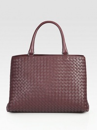 This woven leather design with two convenient compartments is the perfect carryall.Double top handle, 5½ dropTop tie closureTwo inner compartmentsOne inside zip pocketOne inside open pocketSuede lining13¾W X 9H X 8DMade in Italy This woven leather design with two convenient compartments is the perfect carryall.Double top handle, 5½ dropTop tie closureTwo inner compartmentsOne inside zip pocketOne inside open pocketSuede lining13¾W X 9H X 8DMade in Italy