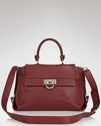 Exquisitely finished and perfectly proportioned. Salvatore Ferragamo's leather satchel with silver tone hardware is an ever-chic piece that pulls together every look. Exquisitely finished and perfectly proportioned. Salvatore Ferragamo's leather satchel with silver tone hardware is an ever-chic piece that pulls together every look.
