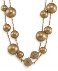 Double up this indulgently gold illusion necklace by Carolee for couture-worthy style. Golden glass pearls and goldtone balls with crystal accents spaced apart on chain crafted in 12k gold-plated mixed metal. Approximate length: 42 inches.