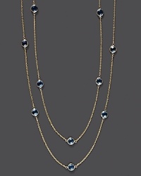 Round checkerboard blue topaz stations gleam on a long, loopable 14K yellow gold chain. Round checkerboard blue topaz stations gleam on a long, loopable 14K yellow gold chain.
