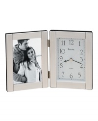 Keep time and memories close to your heart with this elegant picture frame and clock by Bulova. Hinged brushed aluminum case with picture frame at left and clock at right. Dial features black numerals, two black hands and gold tone second hand. Keep time and memories close to your heart with this elegant picture frame and clock by Bulova. Hinged brushed aluminum case with picture frame at left and clock at right. Dial features black numerals, two black hands and gold tone second hand.