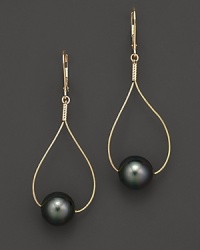Sleek gold teardrops pierce black Tahitian pearls.