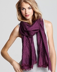Decorated by a jacquard pattern of iconic Ts, this beautiful Tory Burch scarf channels stay-warm style. Decorated by a jacquard pattern of iconic Ts, this beautiful Tory Burch scarf channels stay-warm style.