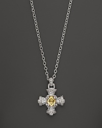 A gleaming canary crystal is set at the center of an ornate cross on this Judith Ripka pendant necklace. A gleaming canary crystal is set at the center of an ornate cross on this Judith Ripka pendant necklace.