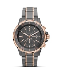 Surrender to sparkle with this Swarovski crystal-rimmed watch from MICHAEL Michael Kors, boasting an oversized case, sleek stainless steel bracelet and chronograph movement.