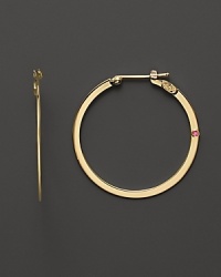 These flat 18K yellow gold hoops are a stunning take on a timeless classic. Set with a signature ruby accent. These flat 18K yellow gold hoops are a stunning take on a timeless classic. Set with a signature ruby accent.