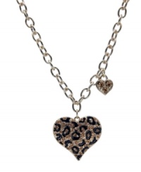 Become one with the animal kingdom. This wild style by GUESS features a leopard print heart pendant with black enamel and crystal accents. Crafted in gold tone mixed metal. Approximate length: 16 inches. Approximate drop: 1-1/2 inches. Become one with the animal kingdom. This wild style by GUESS features a leopard print heart pendant with black enamel and crystal accents. Crafted in gold tone mixed metal. Approximate length: 16 inches. Approximate drop: 1-1/2 inches.