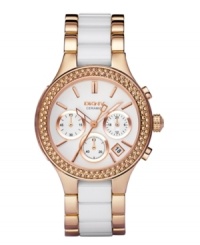 Treat yourself like a queen with the brilliant shine of this rosy watch by DKNY. Polished rose gold ion-plated stainless steel bracelet with center links of white ceramic and round case. Bezel embellished with crystal accents. White chronograph dial features rose gold tone stick indices, date window, three subdials, luminous hands and logo. Quartz movement. Water resistant to 50 meters. Two-year limited warranty. Treat yourself like a queen with the brilliant shine of this rosy watch by DKNY. Polished rose gold ion-plated stainless steel bracelet with center links of white ceramic and round case. Bezel embellished with crystal accents. White chronograph dial features rose gold tone stick indices, date window, three subdials, luminous hands and logo. Quartz movement. Water resistant to 50 meters. Two-year limited warranty.