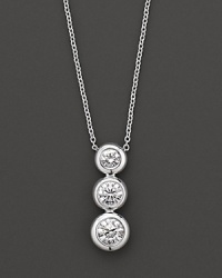 White gold bezel-set diamond necklace in three-stone drop design. With signature ruby accent. Designed by Roberto Coin. White gold bezel-set diamond necklace in three-stone drop design. With signature ruby accent. Designed by Roberto Coin.