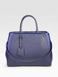 A roomy style in luxurious leather and matching coated twill with signature hardware.Double coated twill top handles, 5½ dropDetachable leather shoulder strap, 13¼ dropSnap strap closureProtective metal feetThree inner compartmentsTwo inside open pocketsFully lined14W X 10¾H X 6DMade in Italy A roomy style in luxurious leather and matching coated twill with signature hardware.Double coated twill top handles, 5½ dropDetachable leather shoulder strap, 13¼ dropSnap strap closureProtective metal feetThree inner compartmentsTwo inside open pocketsFully lined14W X 10¾H X 6DMade in Italy