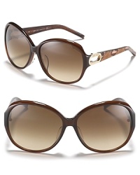 Turn heads in these oversized round sunglasses with open metal temples and reptile print along arms. Turn heads in these oversized round sunglasses with open metal temples and reptile print along arms.