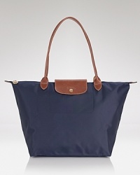 A timeless nod to French style, Longchamp's nylon tote perfects carryall style. This roomy and packable bag is prime for the chic girl, whether she's in-town or overseas. A timeless nod to French style, Longchamp's nylon tote perfects carryall style. This roomy and packable bag is prime for the chic girl, whether she's in-town or overseas.