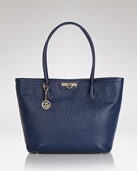 A simple, spacious day-bag with a versatile twist. This Saffiano-finished DNKY tote is subtly structured and secured with a snap, which opens to a lined interior with multiple pockets. A simple, spacious day-bag with a versatile twist. This Saffiano-finished DNKY tote is subtly structured and secured with a snap, which opens to a lined interior with multiple pockets.