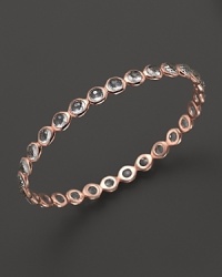 Clear quartz stations dot a polished rose gold bangle from Ippolita. Clear quartz stations dot a polished rose gold bangle from Ippolita.