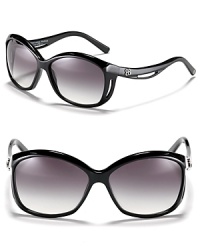 Balenciaga's chic oversized sunglasses feature a curving frame for a unique design. Balenciaga's chic oversized sunglasses feature a curving frame for a unique design.